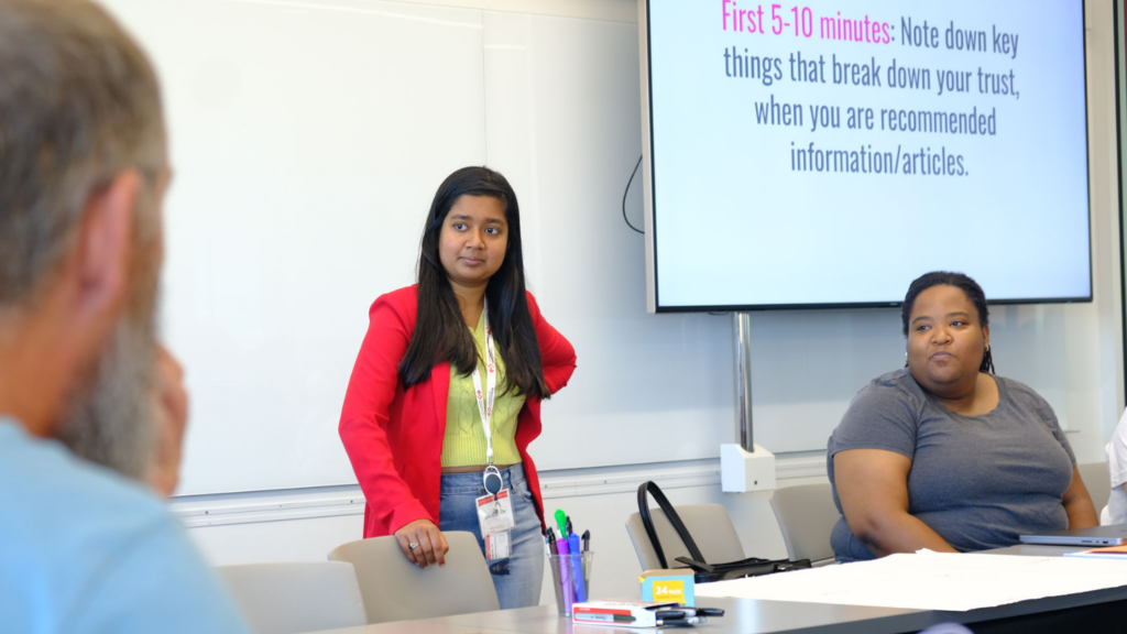 Two students listen to analysts