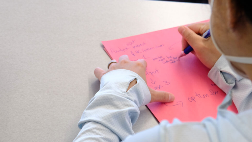 A woman's hand, writing on paper