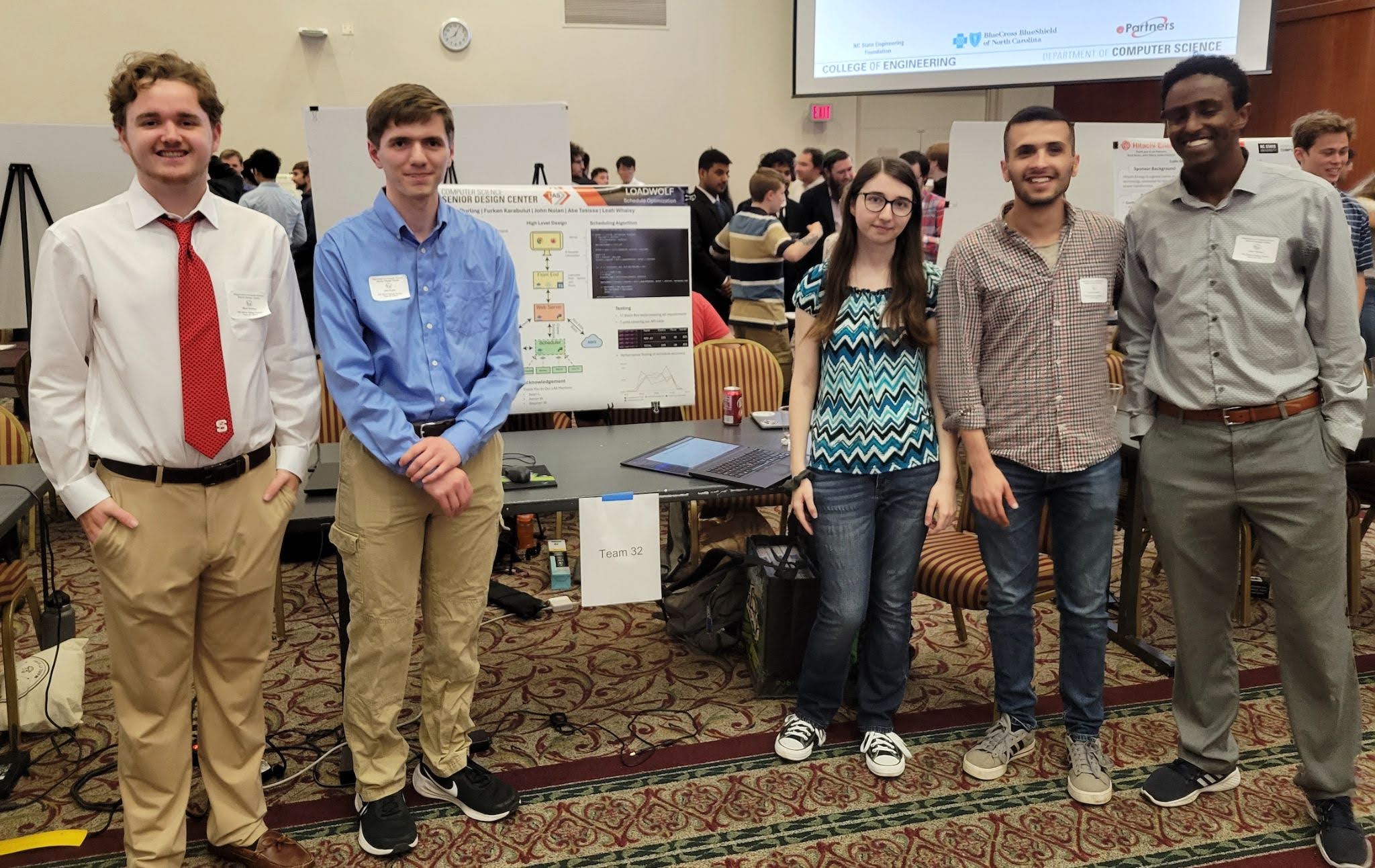 Group of 5 students with a research poster