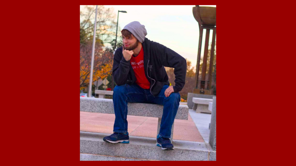 Hayden sitting on a marble bench.