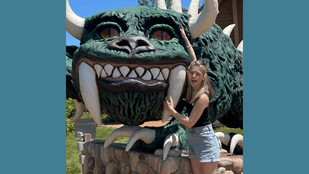 Picture of Gabby standing next to a statue of her favorite cryptid.