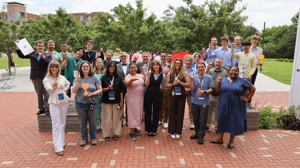 Approximately 30 people posing outside of Hunt Library.